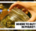 WHERE TO BUY WEED IN PHUKET 2026 - A close-up of a person's hand opening a clear glass latch jar filled with green cannabis flower at the Phuket High dispensary.