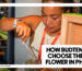 HOW BUDTENDERS CHOOSE THE BEST WEED IN PHUKET - A female budtender wearing a Phuket High lanyard uses metal tongs to carefully select cannabis flower from a glass jar.