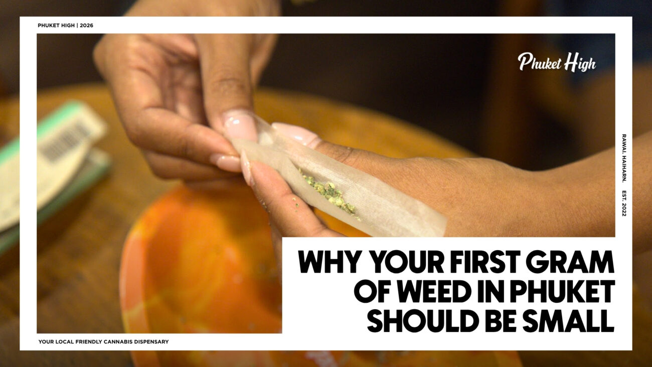 WHY YOUR FIRST GRAM OF WEED IN PHUKET SHOULD BE SMALL - A close-up of a person's hands carefully holding a translucent rolling paper filled with ground cannabis over an orange tray.